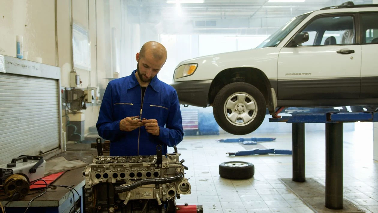 Mecánico revisando un motor en su taller