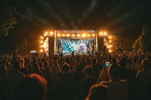 Escenario de concierto con luces de colores y público de noche
